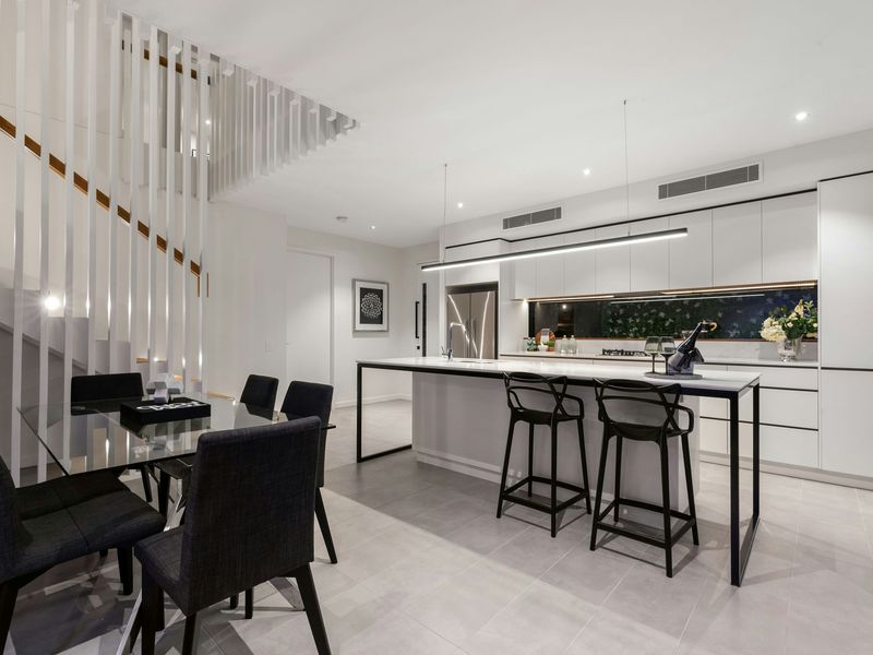 White cabinets with black stools