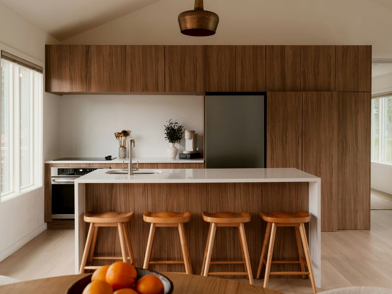 Walnut cabinets and a white island