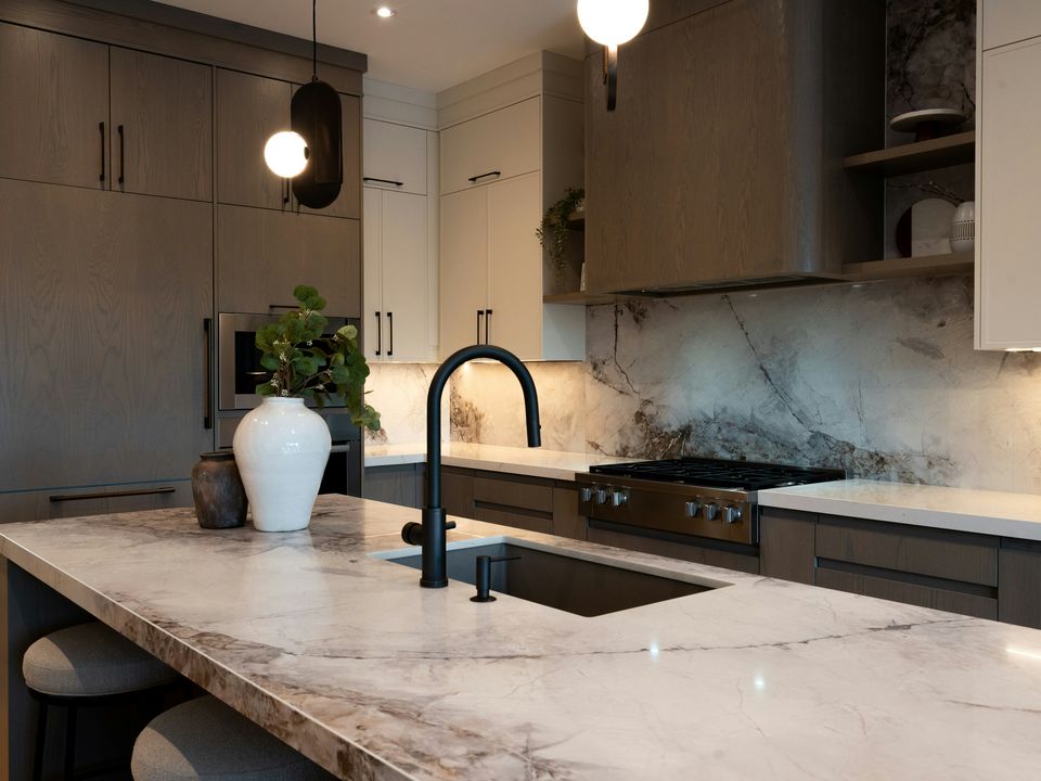 A stone-look island with a dark faucet