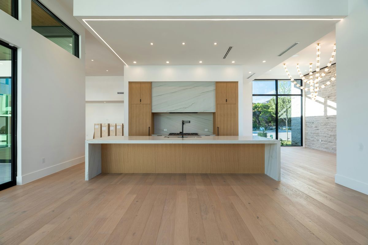 A new kitchen in light wood with a big island
