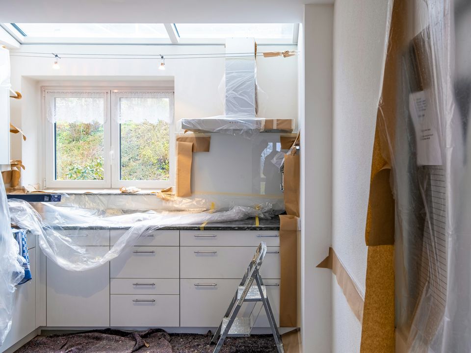 A kitchen in the middle of a remodel, cabinets wrapped